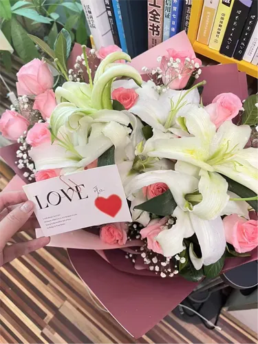bouquet with lily and pink roses and a gift card