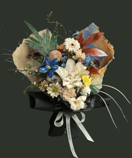 Full double cream lilies with a dyed blue tulip, champagne gerbera and carnations, orchids, rust chrysanthemums, and autumn foliage