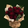 Deep burgundy roses with green foliage in natural kraft-style wrapping