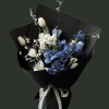 Full white tulips and dyed blue marbled tulips with delicate white flowering branches in black wrapping