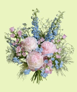 Full blush pink peonies with blue delphinium, pink campanula, baby's breath, and fountain grass