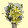 Full cream-yellow perfume lilies, lavender irises, ivory and lilac stock, white seasonal flowers and fresh green foliage
