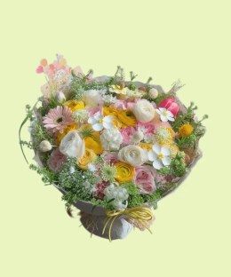 Full pink yellow and white ranunculus with garden roses, gerbera, tulip, lisianthus, craspedia, and lace flowers