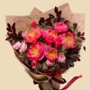 Full coral peonies, blush garden roses, red tulip buds, purple allium buds, and dark smoky foliage