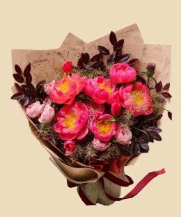 Full coral peonies, blush garden roses, red tulip buds, purple allium buds, and dark smoky foliage