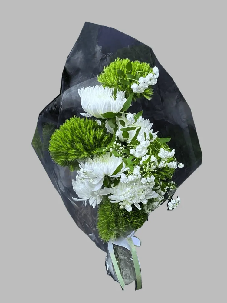 Green Trick dianthus with white chrysanthemums and airy white filler flowers in black wrapping