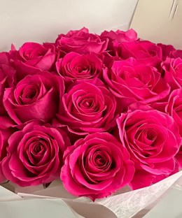 Close-up of vivid fuchsia rose blooms in the Floyd bouquet.