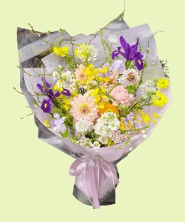 Full blush dahlia, purple iris, pink and orange ranunculus, sweet pea, oncidium, and airy flowering branches