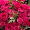 Close-up of fuchsia Floyd-style roses and matching spray roses in the Fuchsia Rose Noir Bouquet