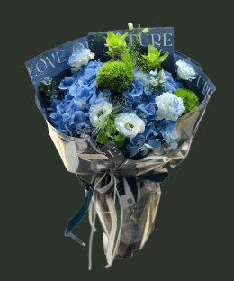 Full blue hydrangea and dyed lisianthus with Green Trick dianthus, green anthurium, blue star flowers, and airy grass