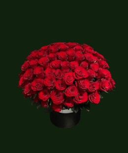 Grand red rose basket arrangement filled with fresh red roses in a classic black hatbox-style container.