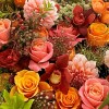 Close-up of orange garden roses, peach-orange dahlias, and burgundy cymbidium orchids in the Harvest Festival Dahlia Bouquet