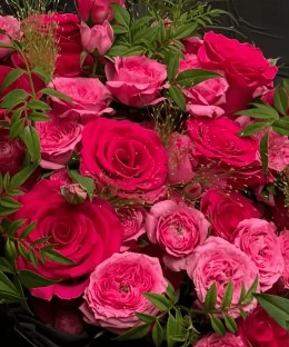 Close-up of hot pink roses and foliage in the Queenberry bouquet.