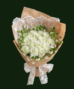 Ivory roses with delicate white accents, greenery, and a lace ribbon bow