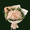 Light pink and cream roses with airy greenery and flowing neutral ribbon