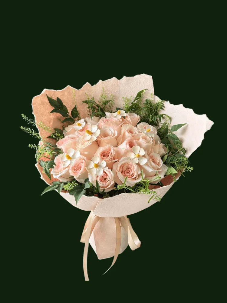 Light pink and cream roses with airy greenery and flowing neutral ribbon