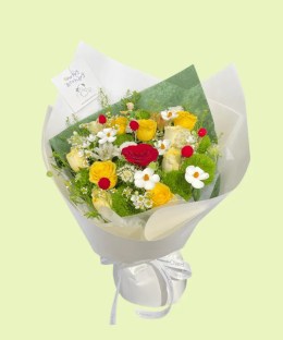 Full red yellow and cream roses, Green Trick dianthus, white ranunculus, meadow flowers, and a Little Prince figure