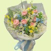Full pink garden roses with chamomile, blue tweedia, yellow butterfly ranunculus, purple scabiosa, and airy grass