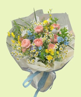 Full pink garden roses with chamomile, blue tweedia, yellow butterfly ranunculus, purple scabiosa, and airy grass