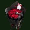 Fresh red roses in structured black wrapping with a wide black satin bow