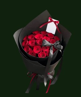 Fresh red roses in structured black wrapping with a wide black satin bow