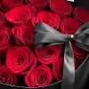 Close-up of red Mamma Mia-style roses and black ribbon detail