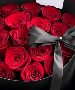 Close-up of red Mamma Mia-style roses and black ribbon detail