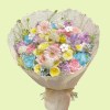 Full pink garden roses, blue hydrangea, purple stock, yellow ranunculus, sweet pea, and blue tweedia in a pastel bouquet