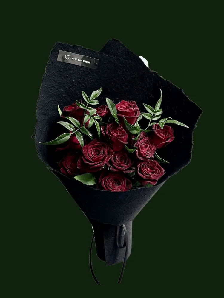 Midnight burgundy roses with variegated leaves in black textured wrapping