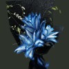 Full cobalt and ice-white dyed Oriental lilies with white flowering branches, dark fern, and black textured wrapping