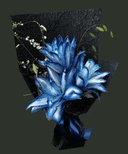Full cobalt and ice-white dyed Oriental lilies with white flowering branches, dark fern, and black textured wrapping