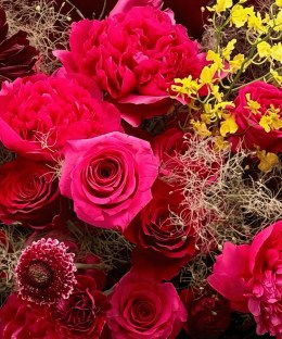 Close-up of fuchsia peonies, red roses, and deep burgundy dahlias in the Midnight Peony & Dahlia Bouquet