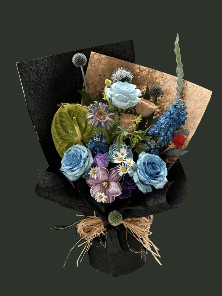 Full dyed blue roses with green anthurium, mauve gerbera, striped tulip, blue delphinium, thistles, daisies, and red gomphrena