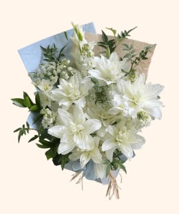 Full double white lilies, white gladiolus, ivory line flowers, lace flower, and fresh green foliage
