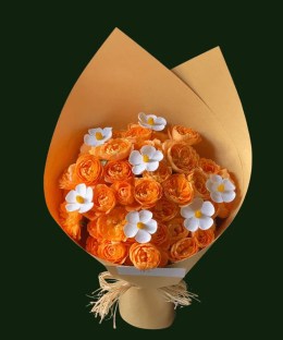Orange roses with small white floral accents in warm ochre wrapping
