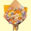Full orange and blush roses, cream tulips, white chamomile, purple sweet pea, blue star flowers and yellow accents