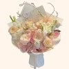 Full blush ranunculus, pink orchids, cream roses, white line flowers, gerbera, tulip, and feathers