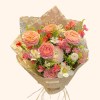 Full peach garden roses, white ranunculus, white tulip, alstroemeria, pink flowers, and green filler