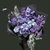 Full gradient purple roses with striped freesia, purple carnations, grape hyacinth, pale line flowers, and silver mist foliage