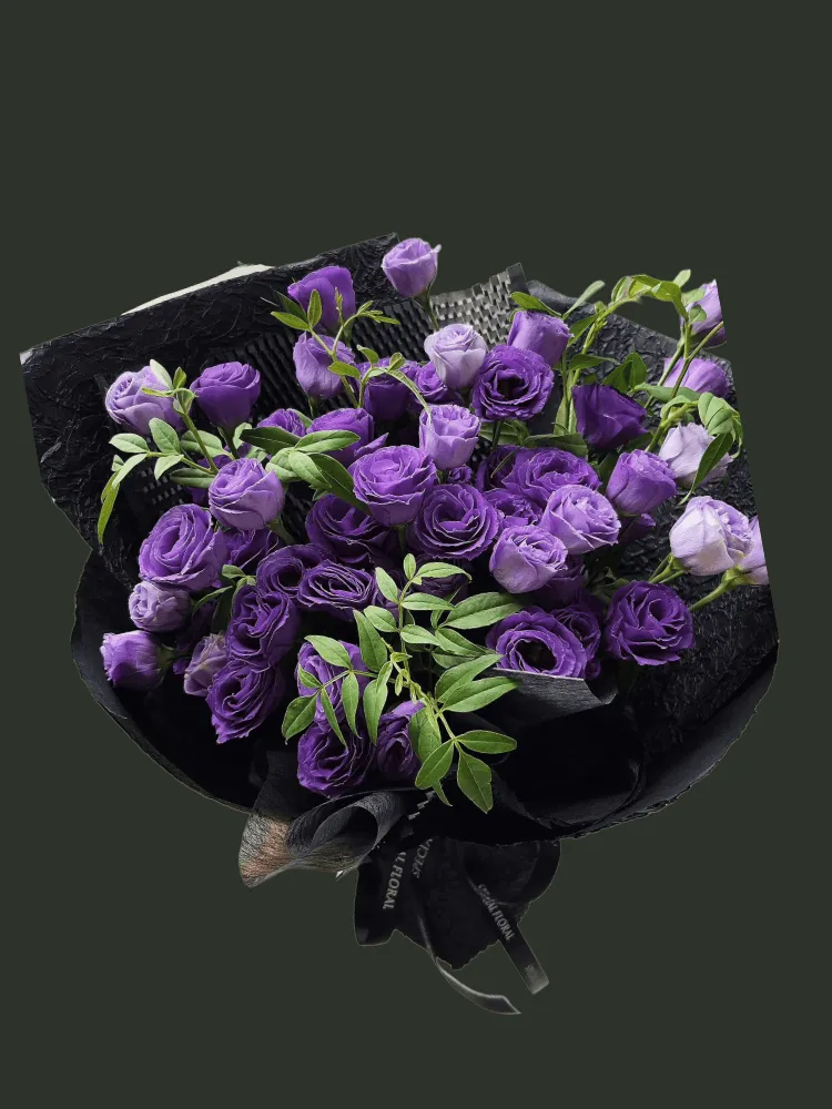 Full deep and pale purple lisianthus with slender green foliage in minimalist black wrapping