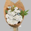 White garden roses and spray roses with blue tweedia in natural brown wrapping
