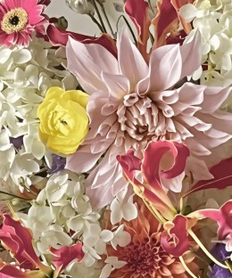 Close-up of blush dahlias with red gloriosa, white hydrangea, pink gerbera, yellow ranunculus, and purple delphinium