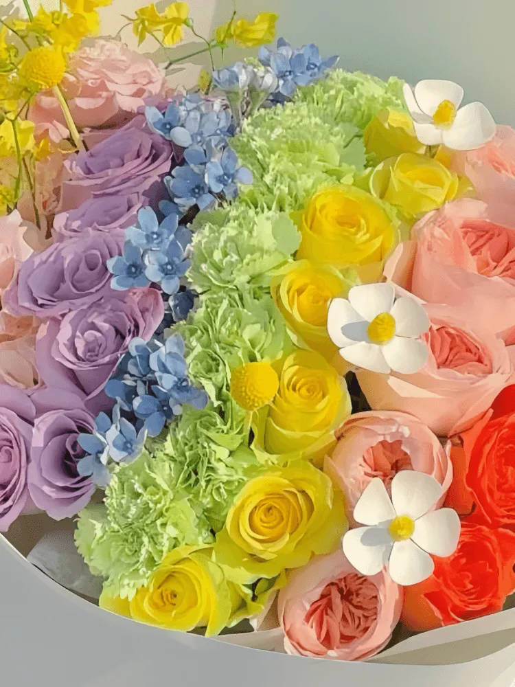 Close-up of pink, lavender, yellow, peach, and red roses in the Rainbow Reverie Rose Bouquet