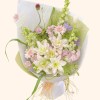 Full blush double lilies, pink gerbera, pale delphinium, white tulip, purple flowers, and misty green grass