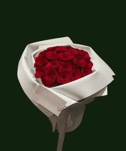 Rich red Explorer-style roses arranged in crisp layered white wrapping