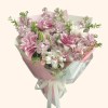 Full double pink lilies, lavender stock, blush spray roses, green lily buds, and fresh foliage