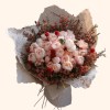 Full blush peonies, red globe flowers, coral waxflower, dark foliage, and cream wrapping