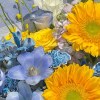 Close-up detail of sunflowers with blue delphinium, blue tulips, violet lisianthus, white gladiolus, and yellow accent flowers