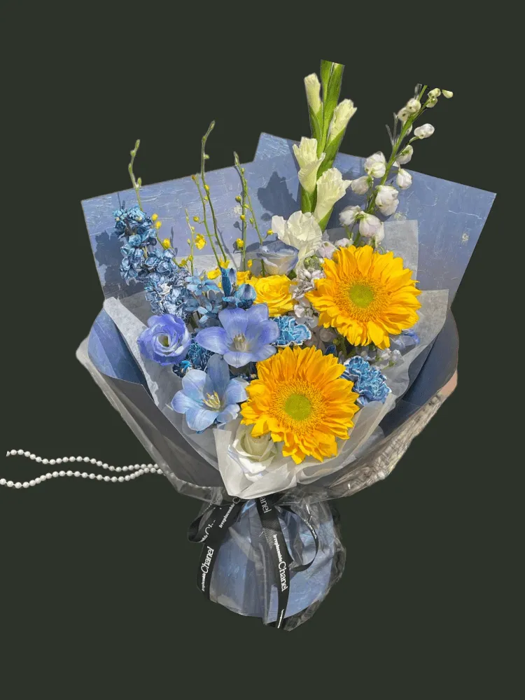 Full sunflowers with blue delphinium, blue tulips, violet lisianthus, white gladiolus, and yellow accent flowers