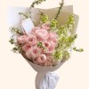 Full peach-pink garden roses, ivory-green stock, flowering spiraea, fresh foliage, and white wrapping